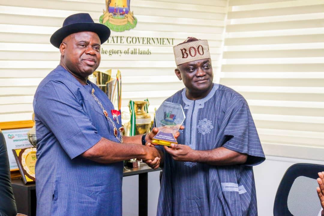 Chairman of the House Committee on Judiciary, Oluwole Oke, receiving a plaque from their host,Governor Diri of Bayelsa State in Government House Yenagoa